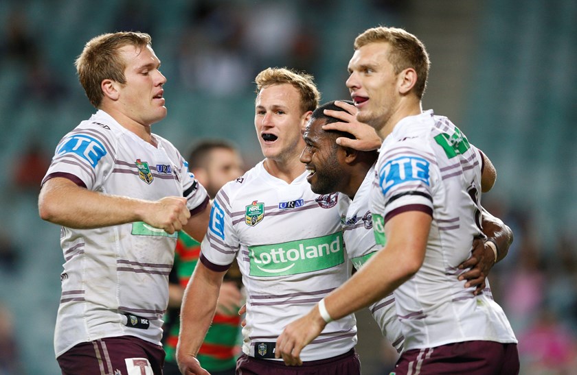 Manly Sea Eagles teammates celebrate a try
