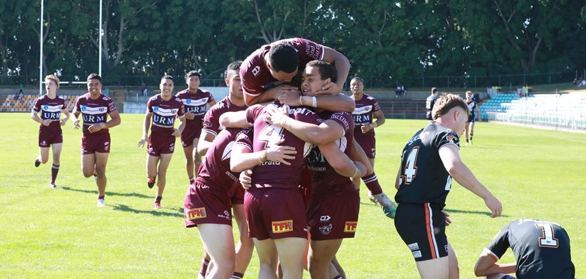 The Manly players celebrate a try to centre Josh Feledy in their win over Wests at Leichhardt. 