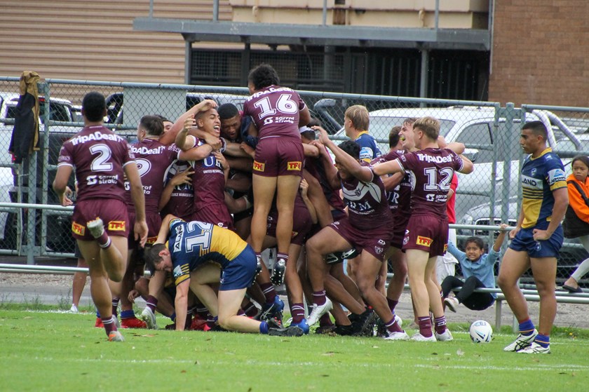 The Manly boys celebrate the match-winning try to Lehi Hopoate
