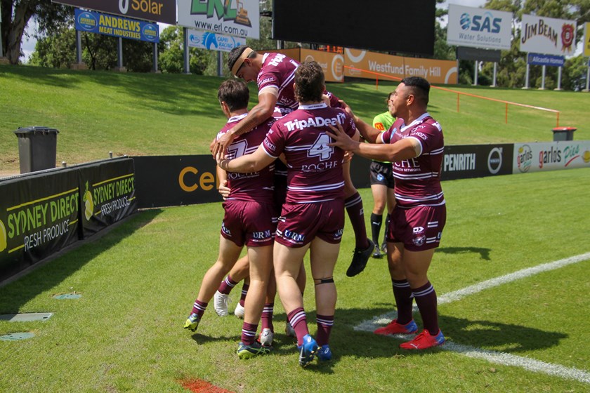 Try time...Manly players celebrate one of Brown's tries.