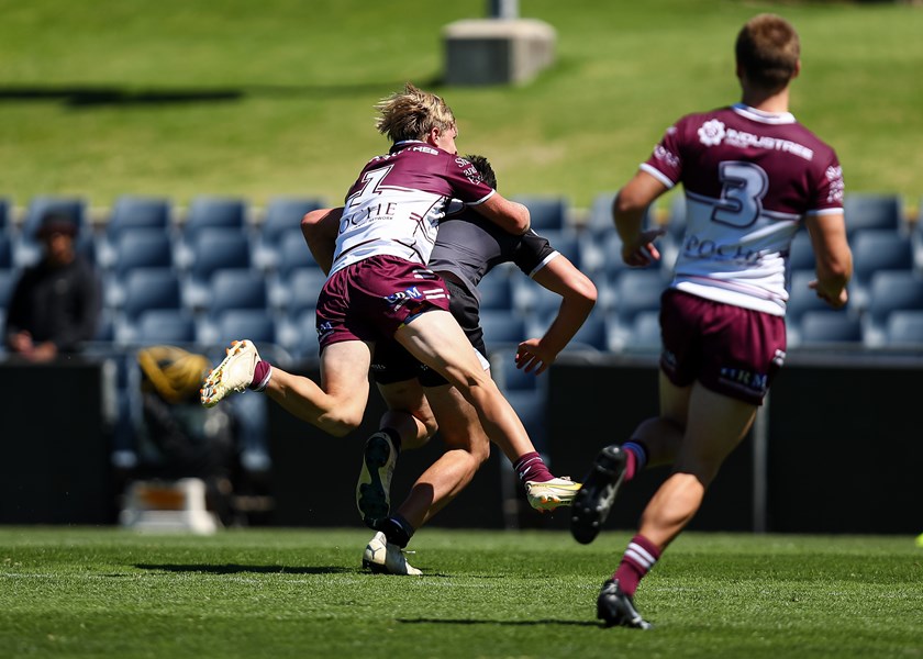 Trapped bird...Sea Eagles full-back Reilly Caswell does his best to reign in a runaway Magpie.