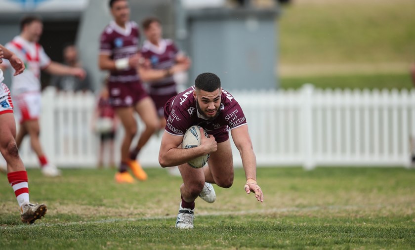 Over he goes....centre Koby Douglas scores for Manly