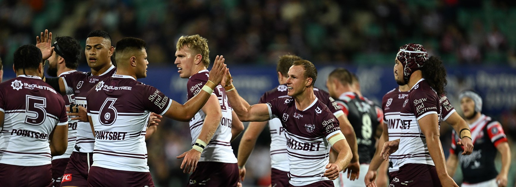 The Sea Eagles celebrate the try to Josh Schuster