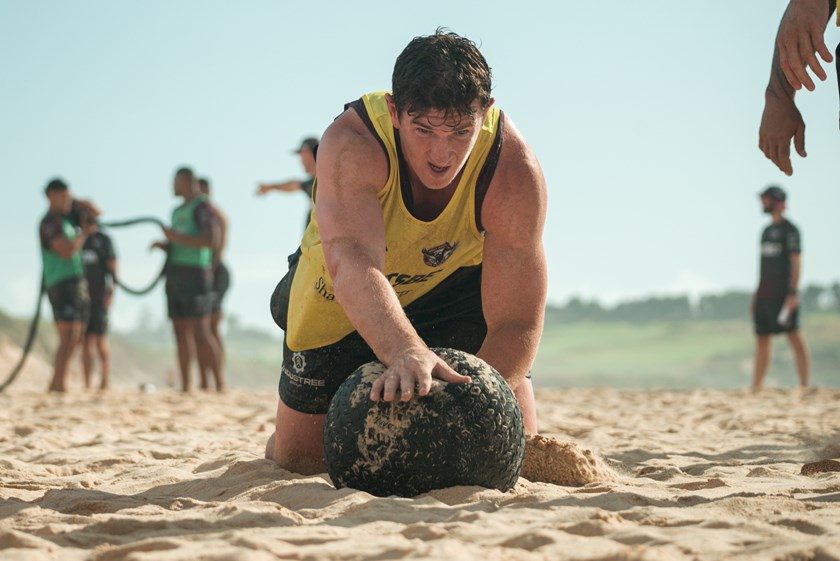 Pain barrier...Ben Condon pushes a medicine ball through the heavy sand at Long Reef Beach during the pre-season  