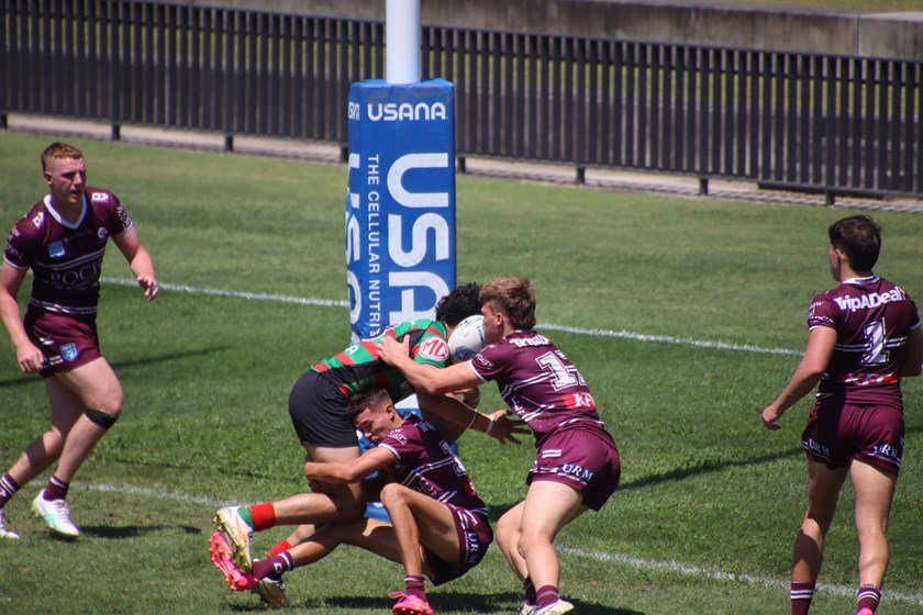 Body on the line...the Sea Eagles make a trysaving tackle against Souths at Redfern Oval today