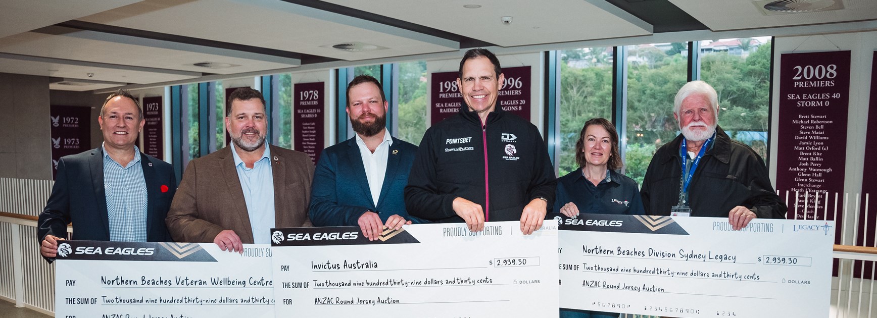 Manly present cheques from ANZAC Round jersey auction